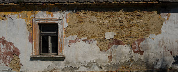 istock Rusty wall and window of abandoned house. 545816858