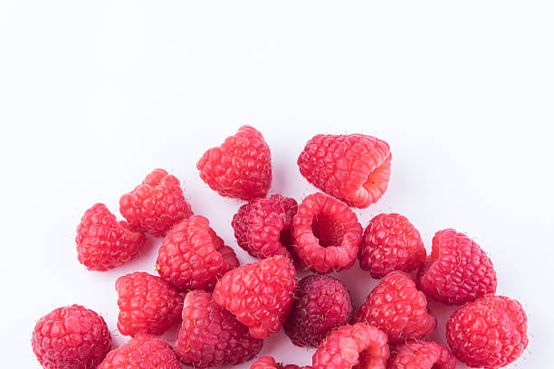 istock Ripe raspberries isolated on white background 545817690