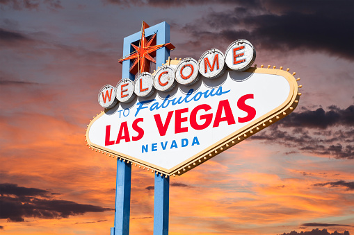 Las Vegas welcome sign with sunrise sky.