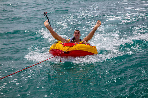 Man sitting in inflatable ring in the water