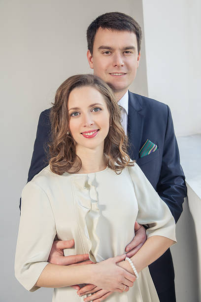 istock Happy wedding couple posing in bright room embracing each other 545818714