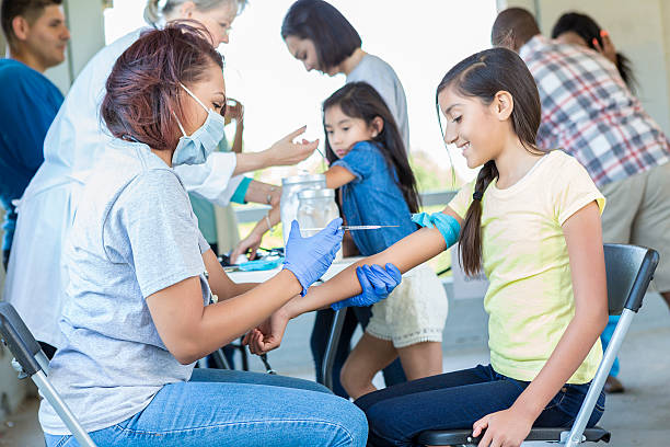 istock Young hispanic girl about to get a shot 545980418