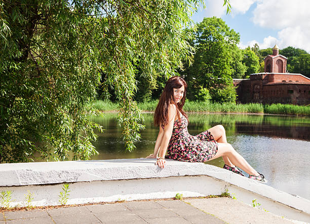 istock beautiful brunette sitting near the lake 545981530