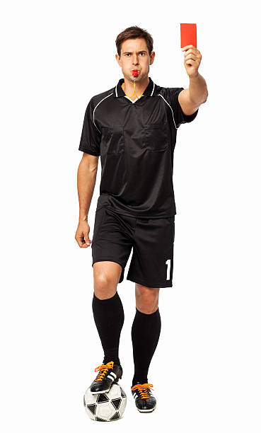 An American football referee tossing his yellow penalty flag at the camera, with lens flare.This also could be a lacrosse referee.