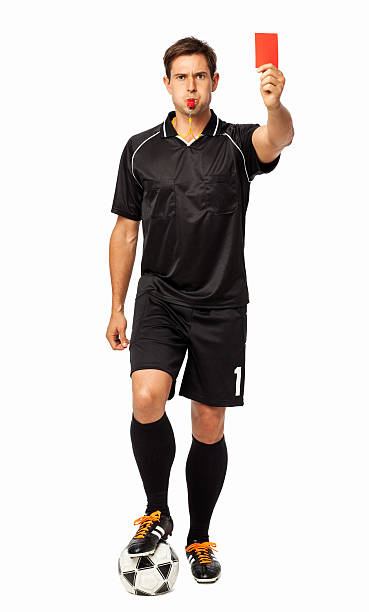 Referee With Soccer Ball Showing Red Card Full length portrait of referee with soccer ball showing red card over white background. Vertical shot. referee stock pictures, royalty-free photos & images