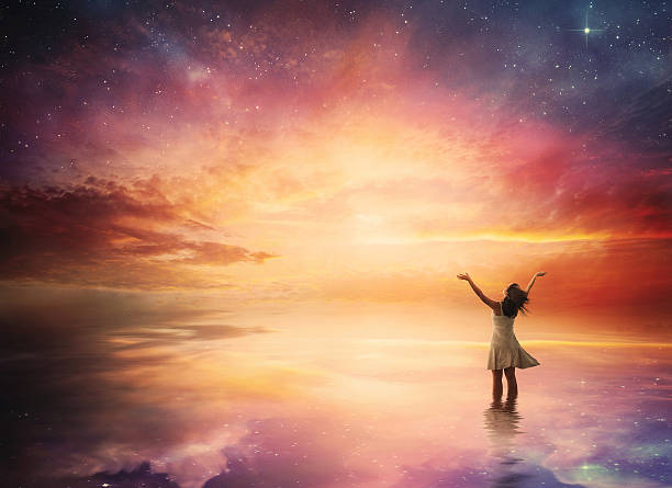 Night sky praise Woman stands in praise before a beautiful night sky. spirituality stock pictures, royalty-free photos & images