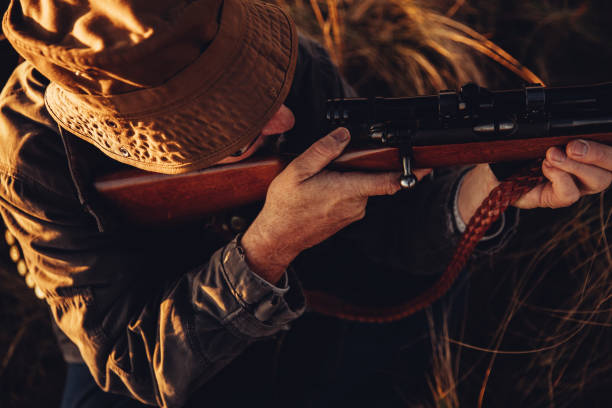 istock High angle view of hunter loading his rifle to shoot 545983512