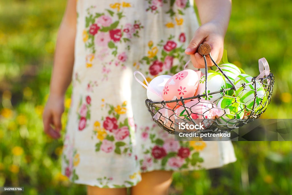 Close up of colorful Easter eggs in a basket Close up of colorful Easter eggs in a basket in hands of a little girl Baby - Human Age Stock Photo