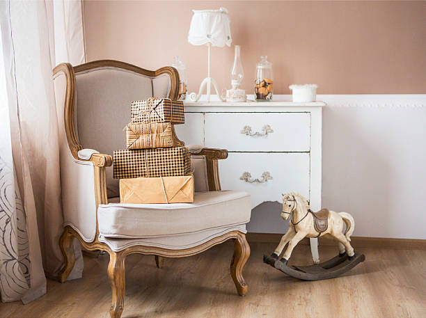 Plastic toy furniture table with chairs on white background, selective foreground focus. Model of miniature doll house furniture.