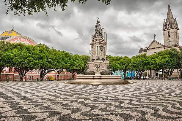 Photo of Praca Sao Sebastiao (St. Sebastian Square) with the Amazon Theatre and the Sao Sebastiao church in downtown Manaus, a city in the heart of the Amazon rainforest, in the state of Amazonas, Brazil.