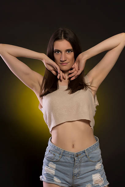 istock Smiling brunette woman in jeans shorts at studio 545986550