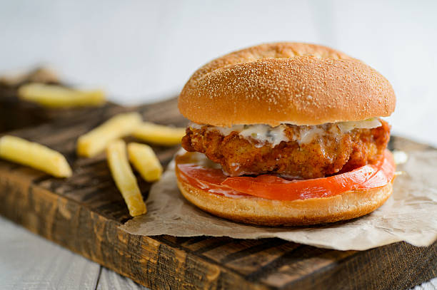 istock Fresh tasty chicken burger on wooden table 545988020