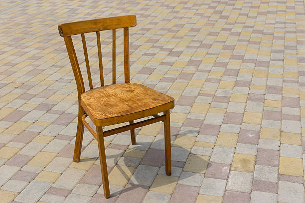 istock Old wooden vintage chair on a pavement 545988292