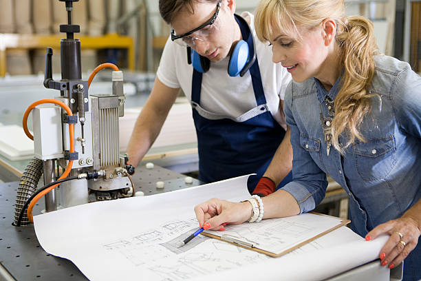 istock Designer with worker at furniture workshop 545988624