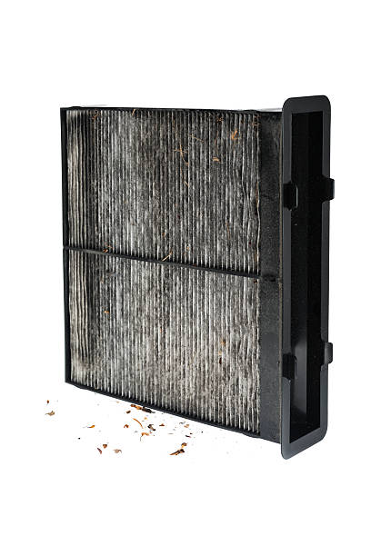 Dirty automobile interior cabin air filter on white background