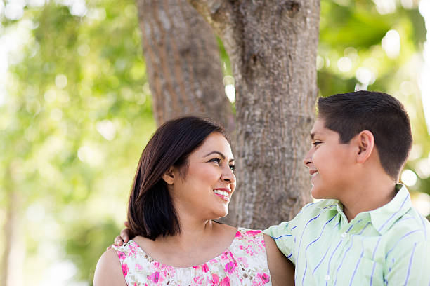 istock Mature latin mother and son smiling at each other 545989686