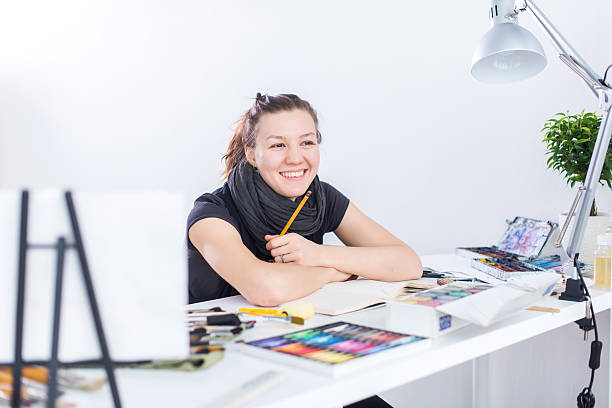 istock Young female artist drawing sketch using sketchbook with pencil at 545990010