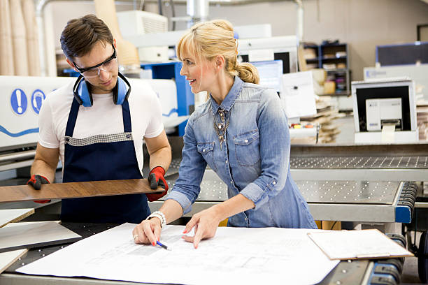 istock Designer with worker at furniture workshop 545990394