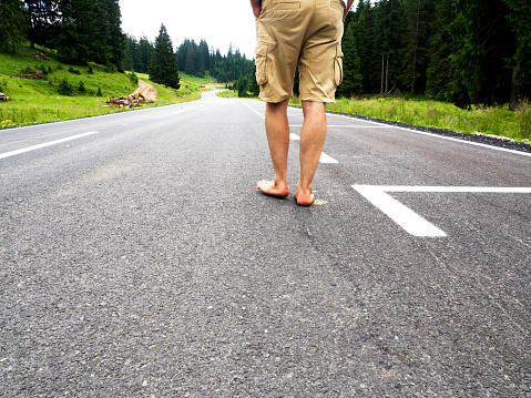 barefoot man on road