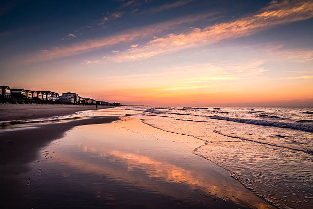 istock Beachfront vacation cottages at sunrise with pastel sky 545991778