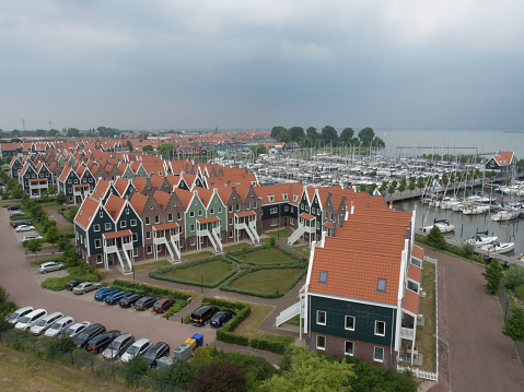The Netherlands, Volendam - June 12, 2016: Cottages and harbor (seen from a height of 28 meters), in the Marina Park at Volendam, The Netherlands.
