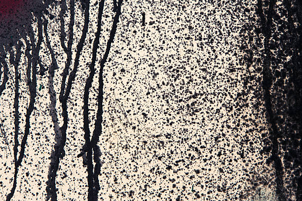 istock Beige concrete wall with black paint drips, abstract background 545993462