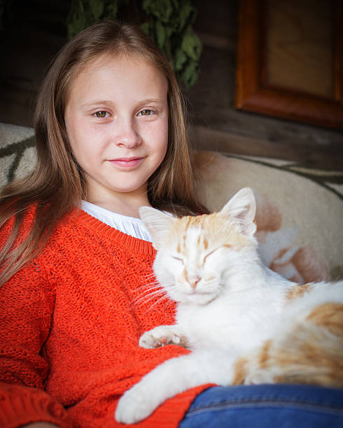 istock Country girl stroking a cat. 545993646