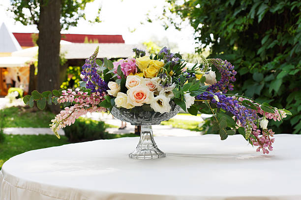 istock Beautiful flower bouquet outdoors. Wedding floristic decoration at white table 545993776