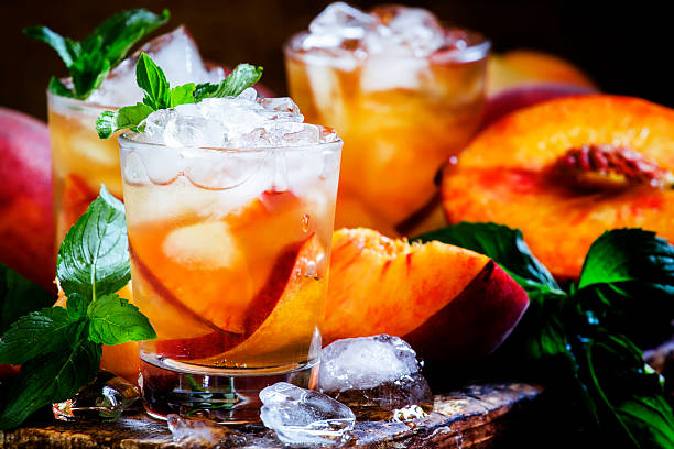 istock Cold black tea with peach juice 545995386