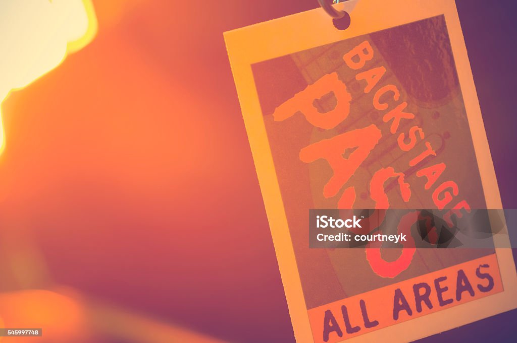 Backstage pass. Backstage pass. The backstage pass is access all areas with orange back light. Arts Culture and Entertainment Stock Photo