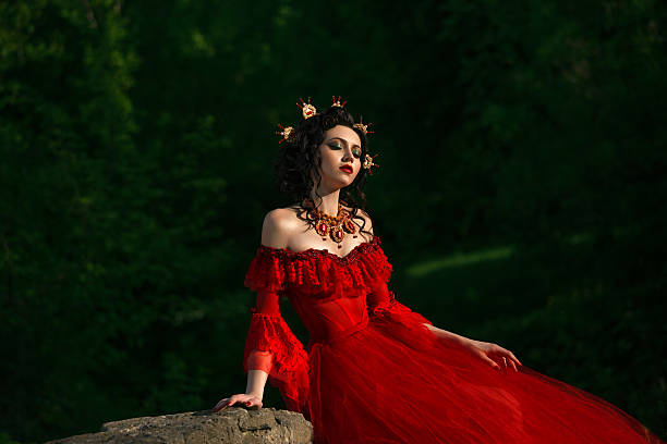istock Lady in a luxury lush red dress 545999436