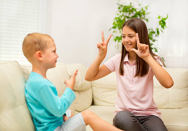 istock Brother and sister learn sign language at home 546000006