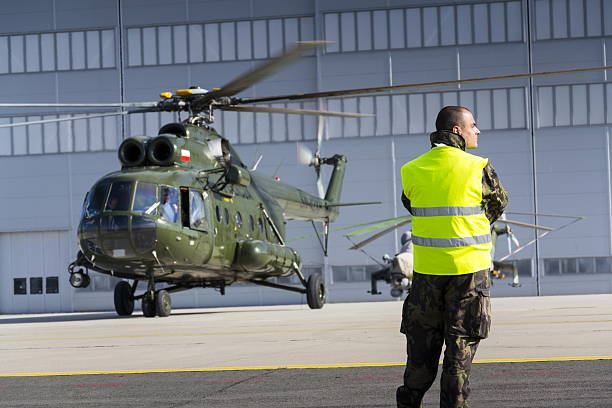 Man in military uniform in front of polish Mi-8T helicopter stock photo