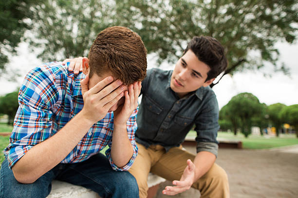 istock Young man sitting beside friend with negative emotion 546001238