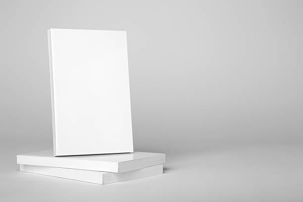 istock Real paperback white book over a stack of books 546001544