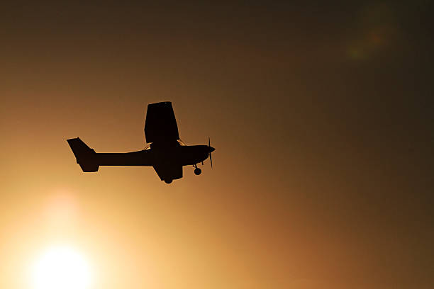 istock plane flies against the backdrop of the sunrise 546001674
