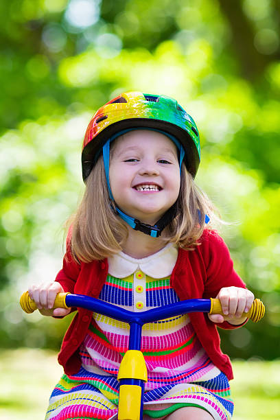 istock Little girl riding a tricycle 546002524