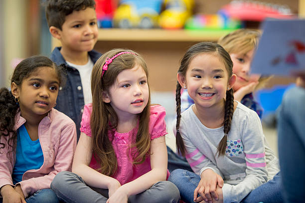istock Listening to a Teacher Read a Book 546003192