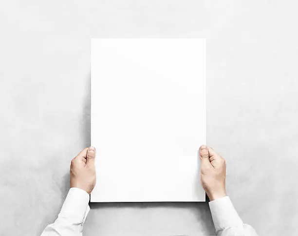 Photo of Hand holding white blank poster mockup, isolated.