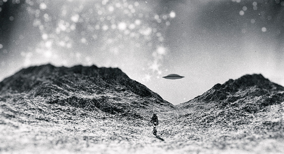 Astronaut walking towards UFO.