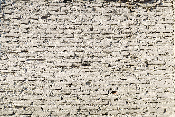 istock Old Vintage white brick cement wall texture background 546011424