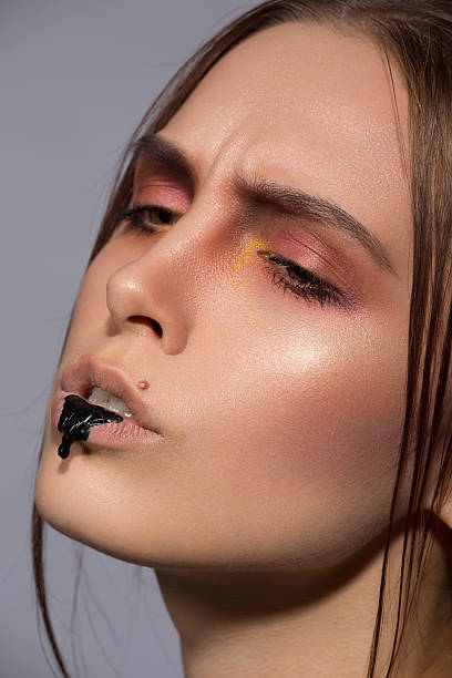 istock beauty creative makeup with black drib on lips 546011658
