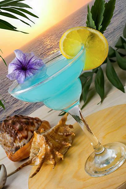 istock Blue cocktail on the tropical sea sunset background 546013250