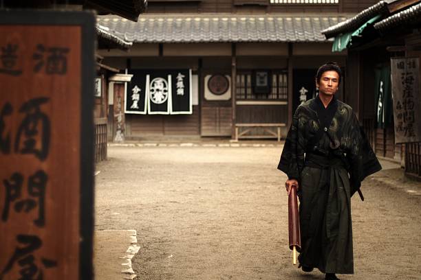istock Samurai walking  street with umbrella 546015690