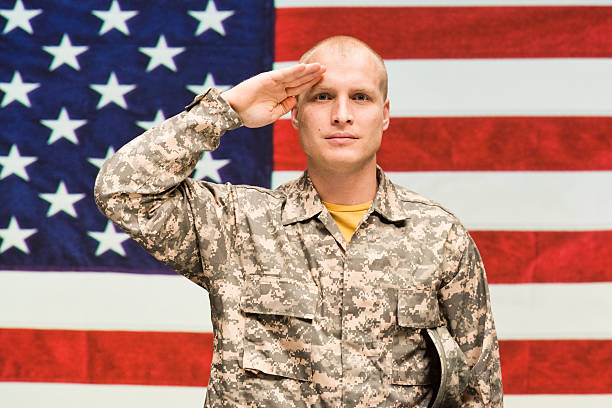 istock Soldier saluting and looking at camera 546016080