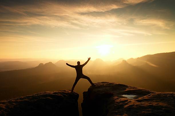 istock Hiker in black triumph between two rocky peaks 546017998