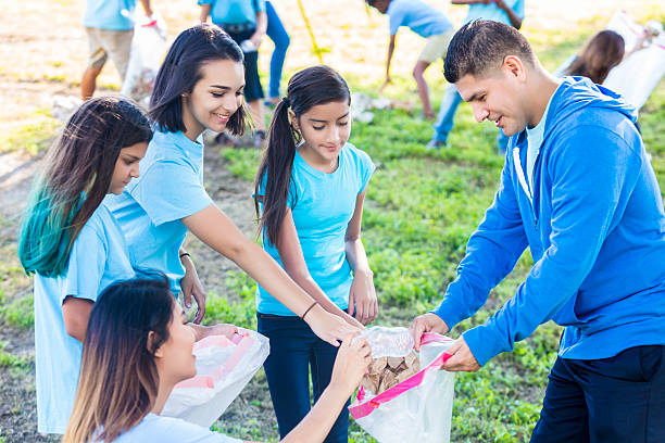 istock Hispanic family picking up trash in the park 546018018