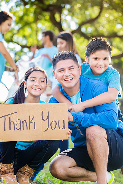 istock Hispanic father and his children help with park beautification 546018140