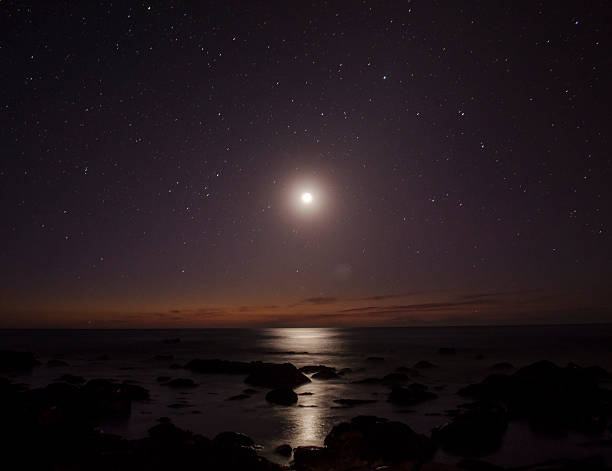 istock Moon on the beach reflexting light on the sea 546018528