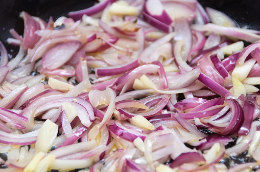 Cooking red onions and garlic in a pan